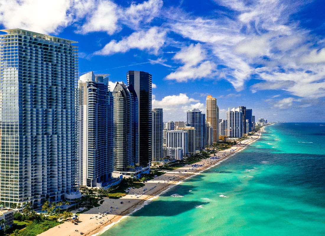 Contact - Row of Skyscrapers in North Miami Along the Beach with Turquoise Water on a Beautiful Sunny Day
